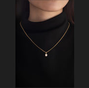 Old mine-cut laboratory-grown diamond 1-carat bezel-set pendant necklace with beaded chain.