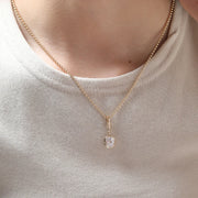 Long, old mine-cut, laboratory-grown diamond 2-carat bezel-set pendant necklace with cross chain.